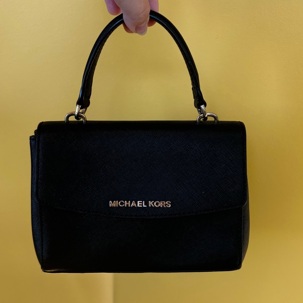 Michael Kors mini bag. Black and gold. No damage. Strap included.